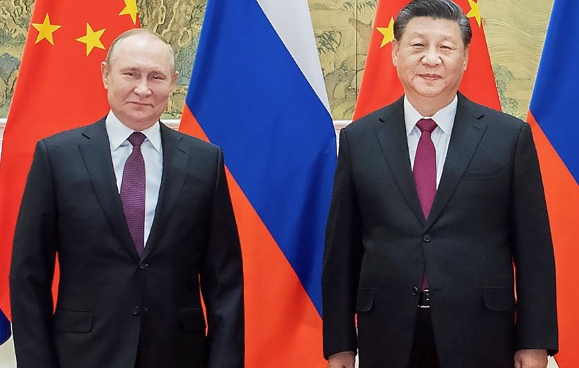Putin and Xi stand side by side